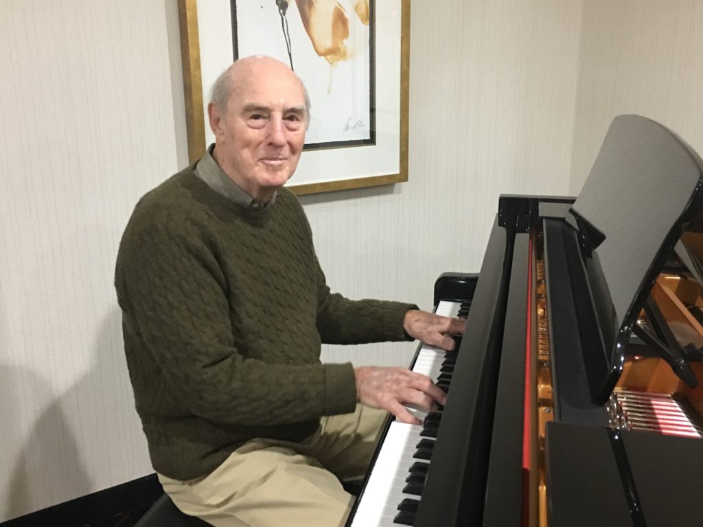 An independent living resident enjoys one of two grand piano's at Oakmont Rochester Independent! 