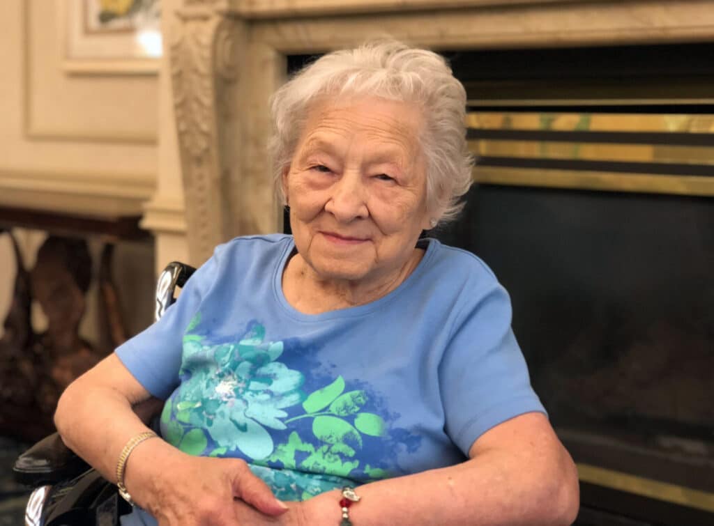 Elderly woman smiling during spotlight photo