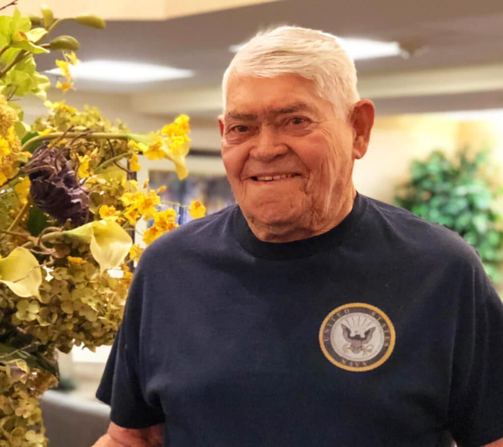 Elderly man smiling indoors during Easter