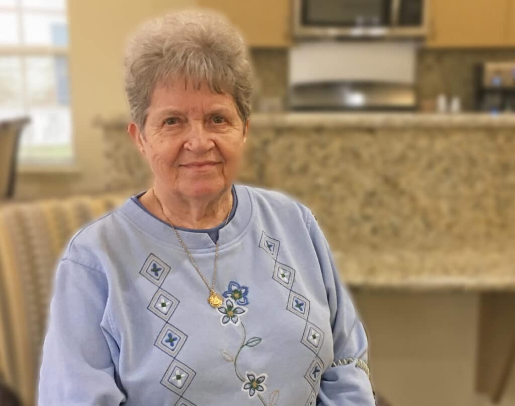 Elderly man smiling indoors during activity