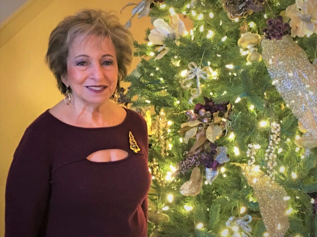 Elderly woman smiling while seated indoors