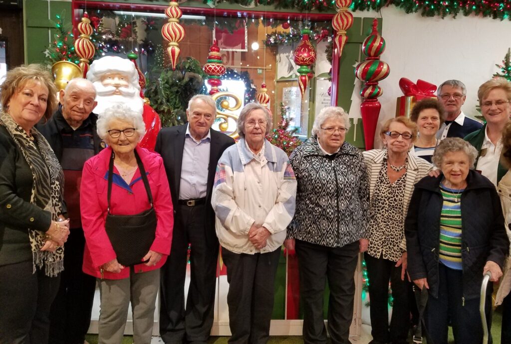 Group of people smiling indoors for event photo
