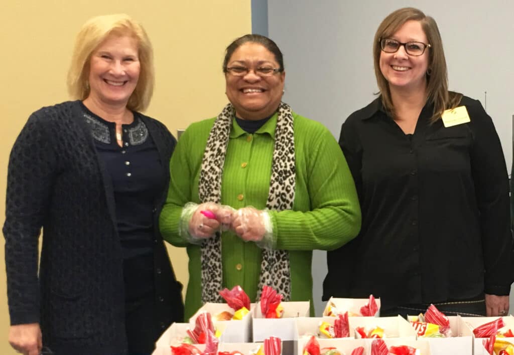 Elderly woman smiling while seated indoors