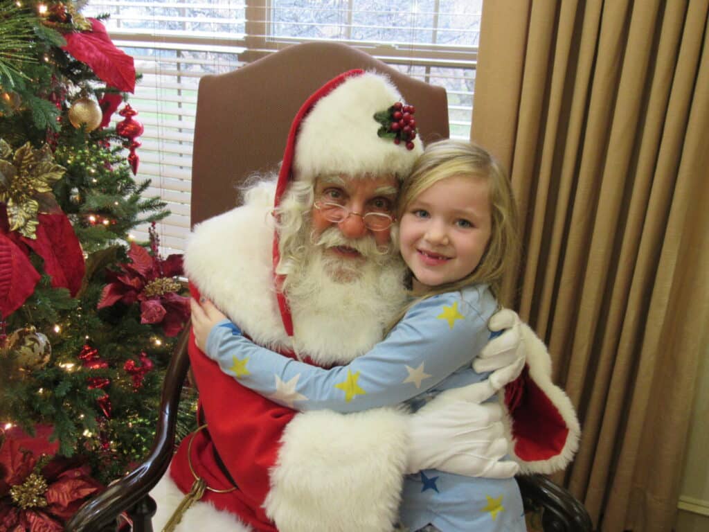 Elderly woman smiling while seated indoors