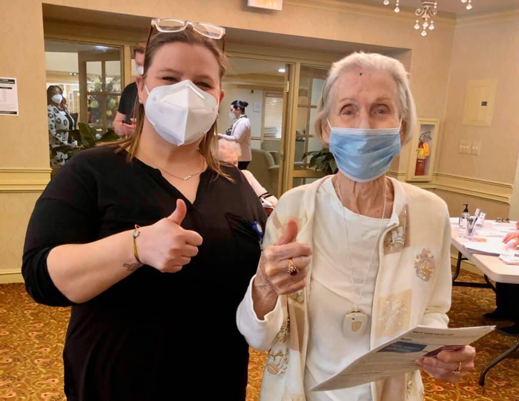 Seniors smiling and wearing masks in community center