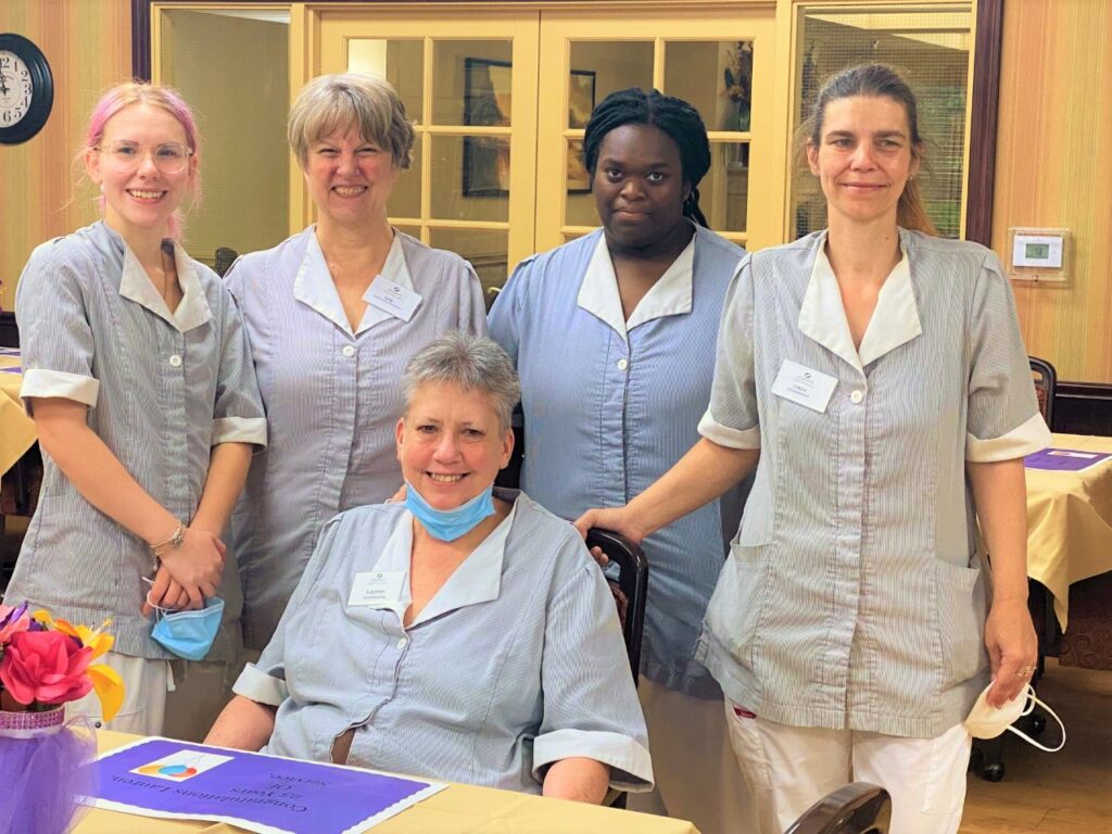 Group of senior residents smiling together in a community activity
