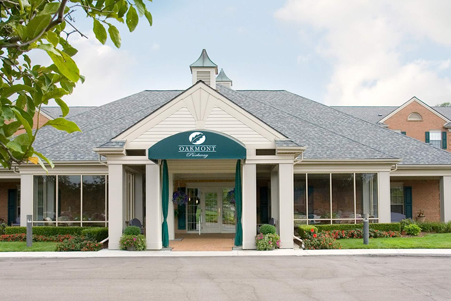 Exterior entrance of Parkway senior living community with landscaped walkway