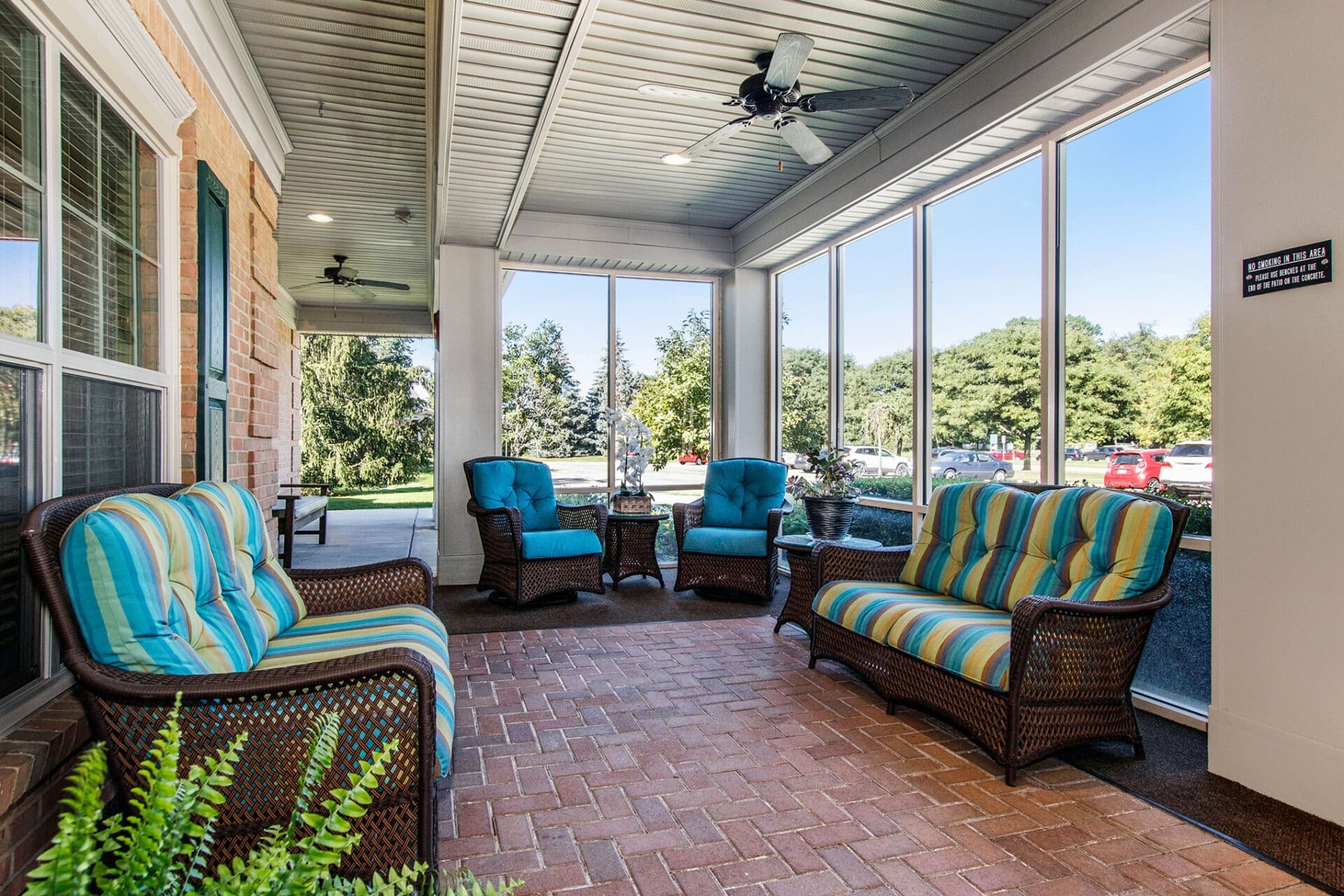 Sunroom lounge with large windows and comfortable seating at Parkway
