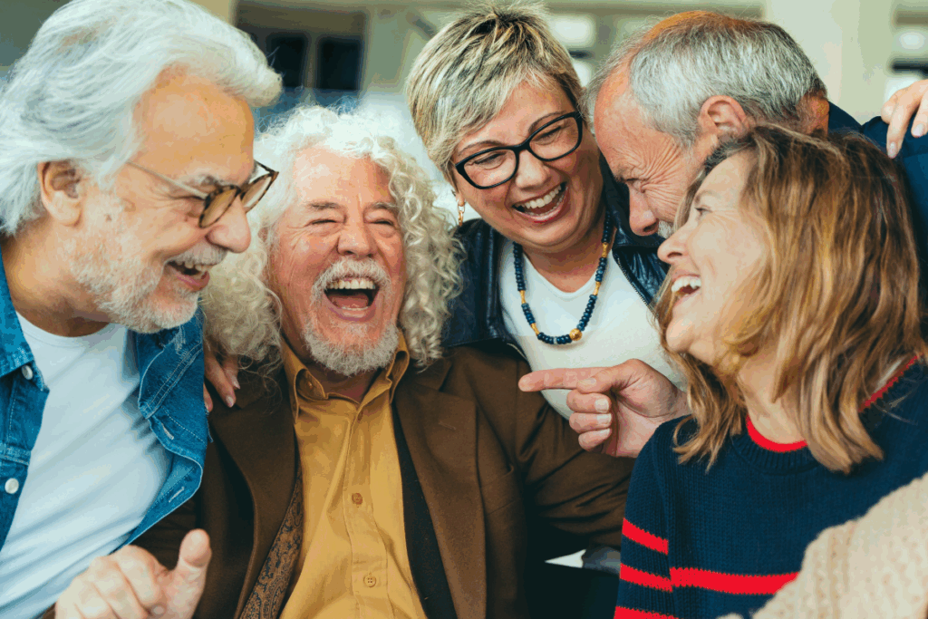 Happy group of older adults laughing together indoors.